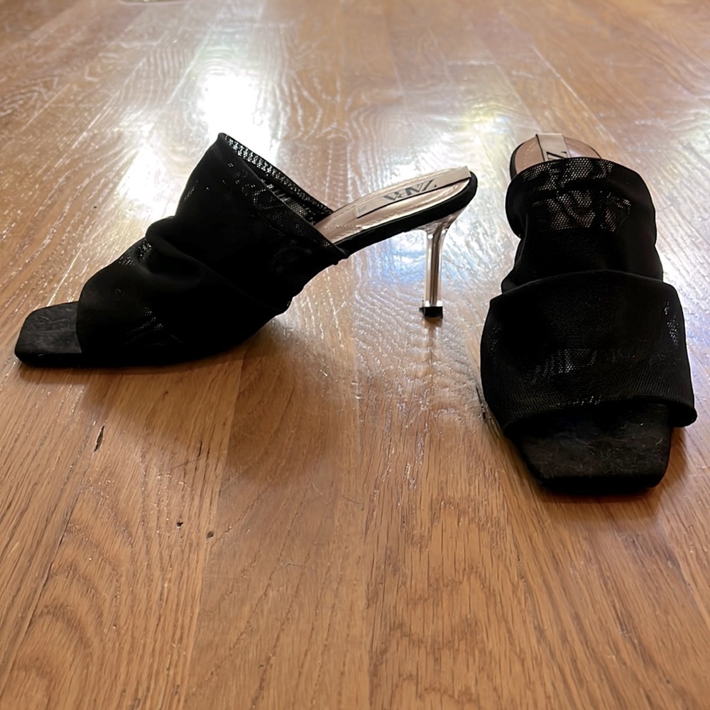 Black mesh slip on sandals.